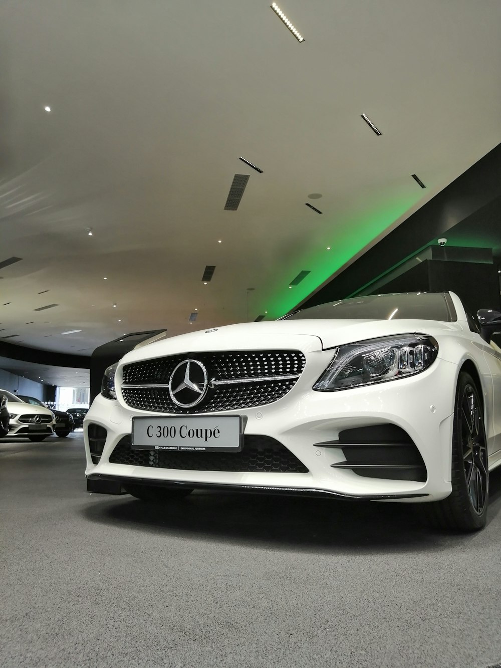 white Mercedes-Benz vehicle close-up photography