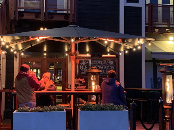 A cozy outdoor seating area with patrons enjoying their drinks.