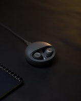 grey Bluetooth earpiece with case