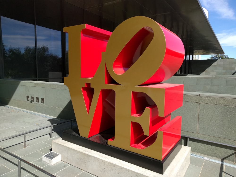 red and yellow love free standing letter close-up photography