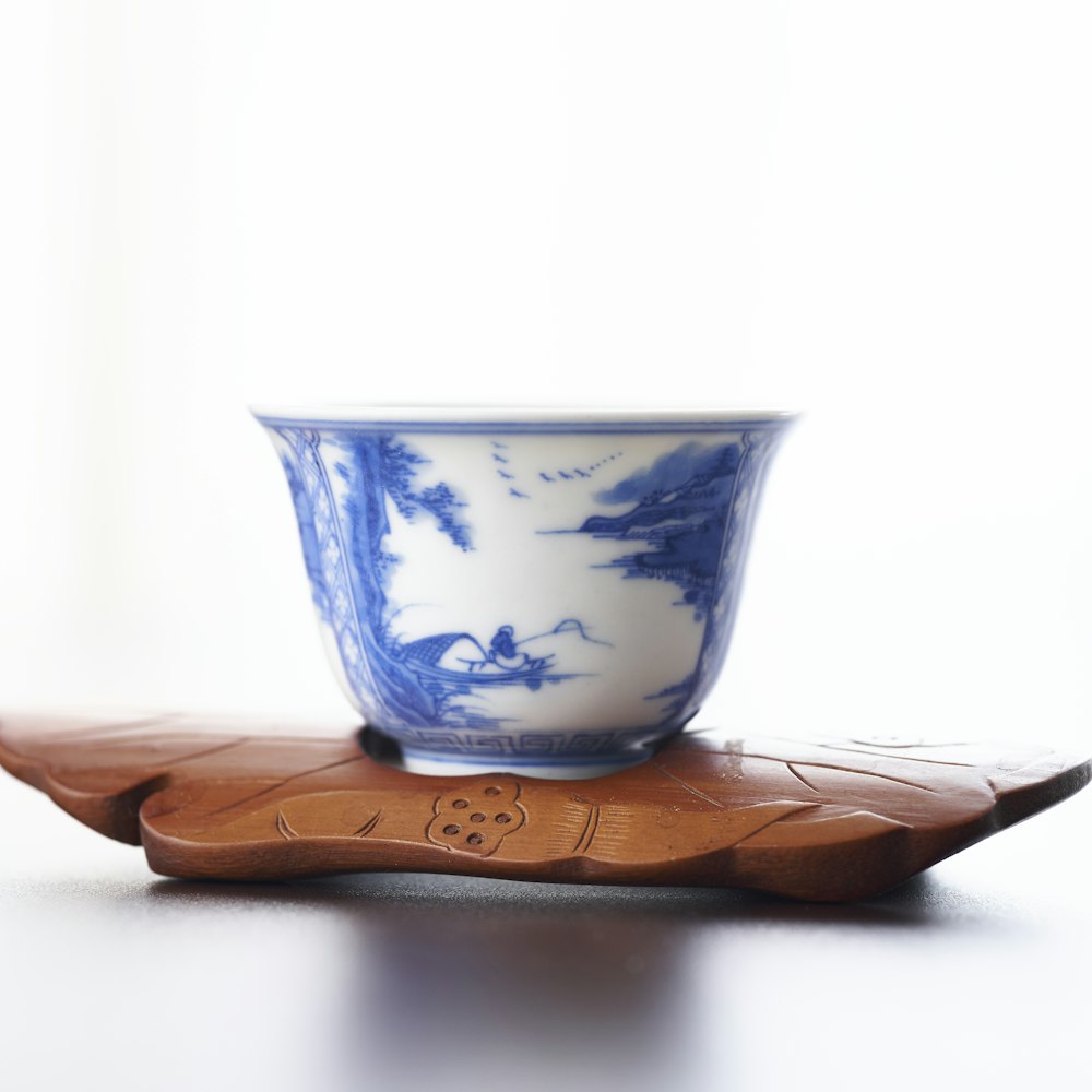 white and blue ceramic cup