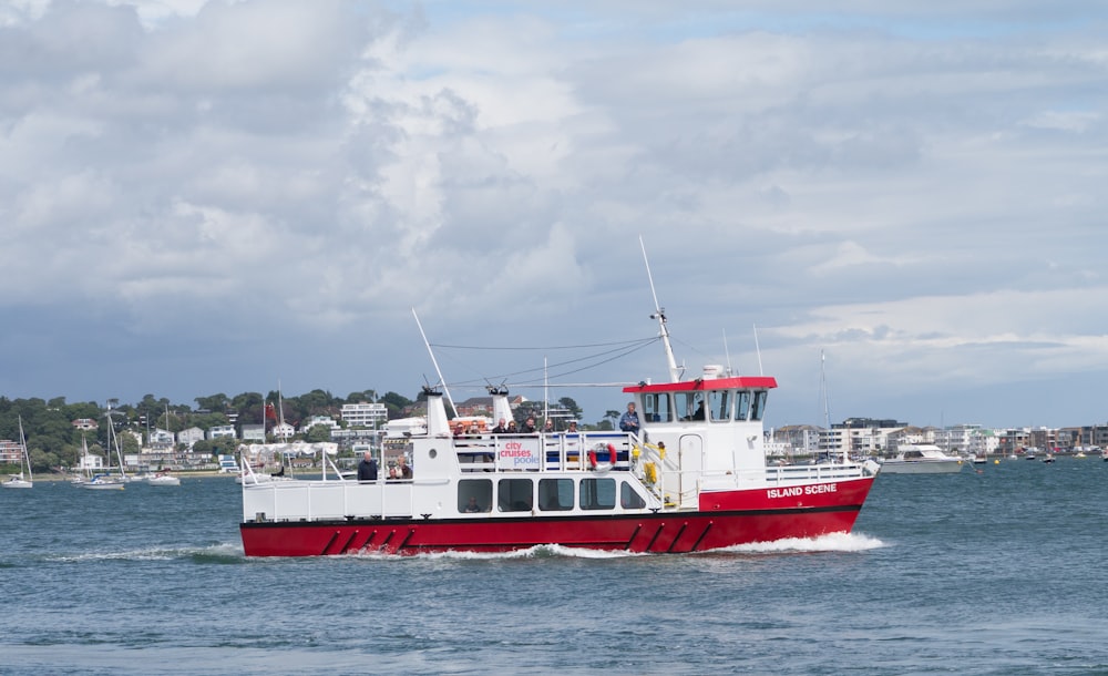 white and red boat on blue sea