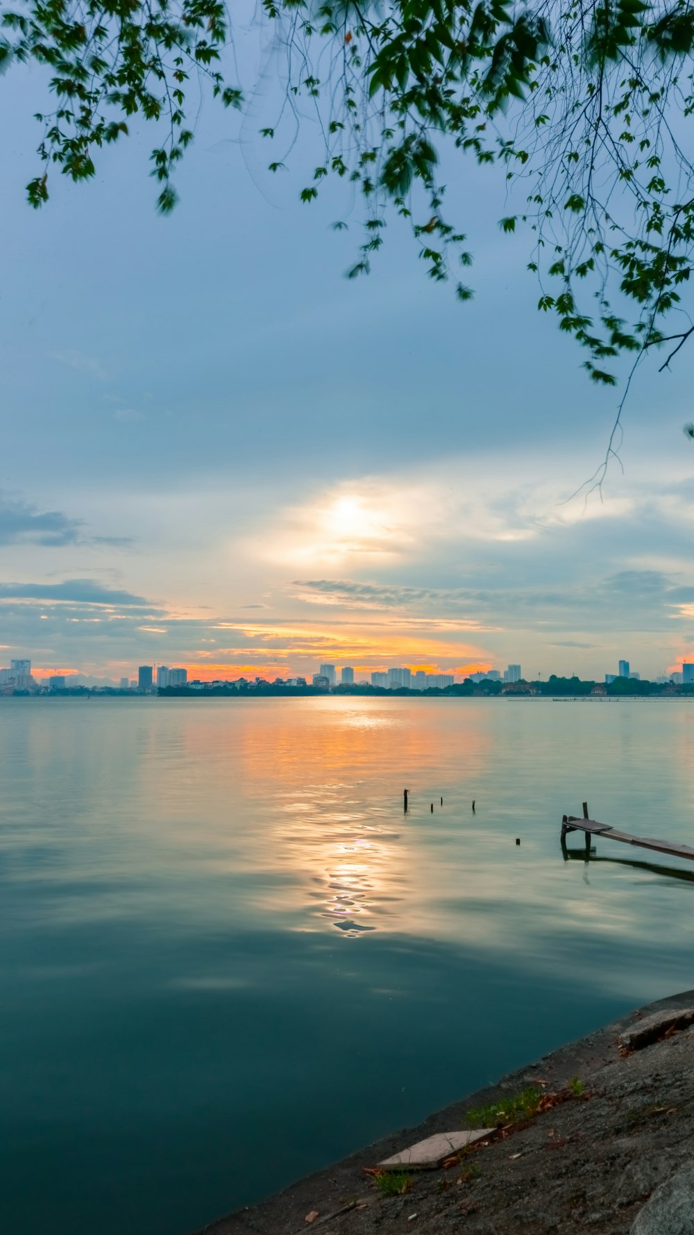 body of water near buildings at golden hour