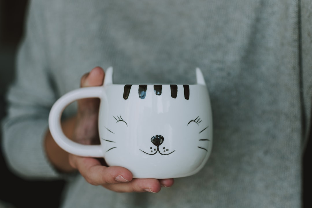 white and black ceramic mug