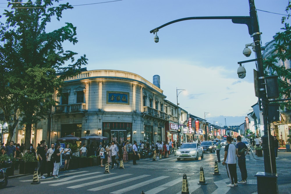 people walking near road beside buildings