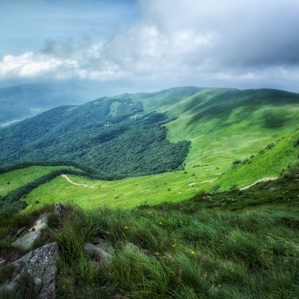 green mountain under white and blue sky at daytime