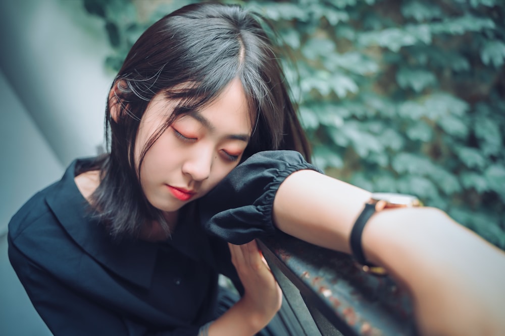 woman leaning on metal railings