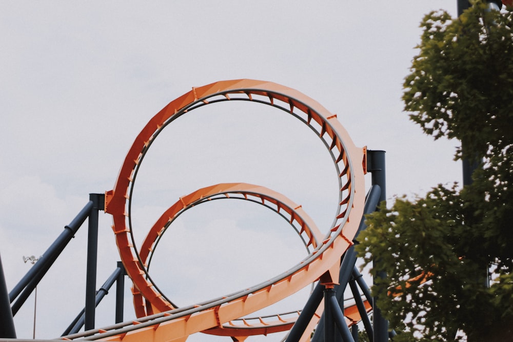 architectural photography of orange and blue roller coaster rail