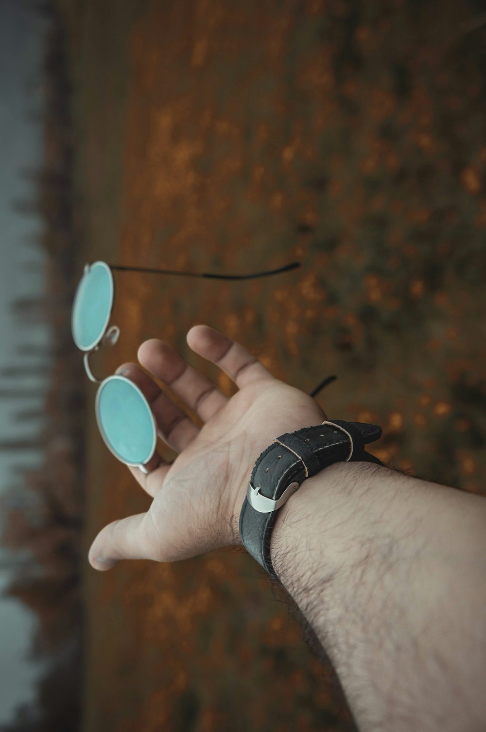 man holding hippie sunglasses