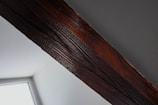 Close-up of skilled carpentry work on a wooden beam inside a residential home.