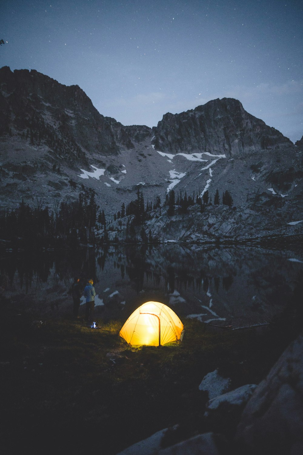 tent near tree and hill during daytime