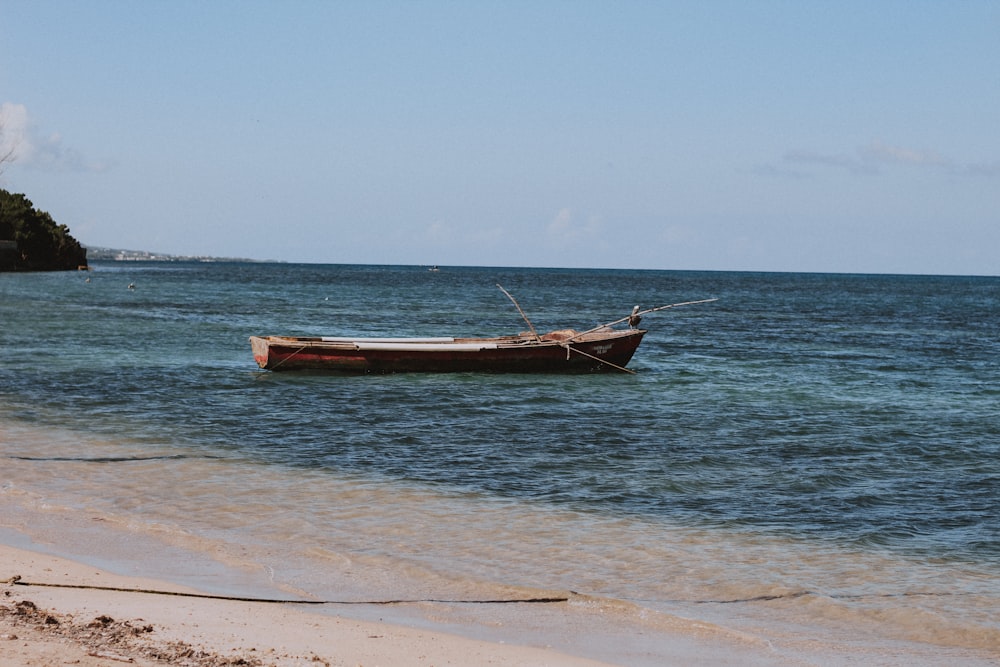 brown boat near shore