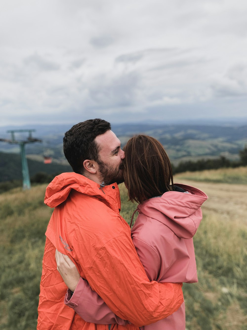 man and woman standing on hill