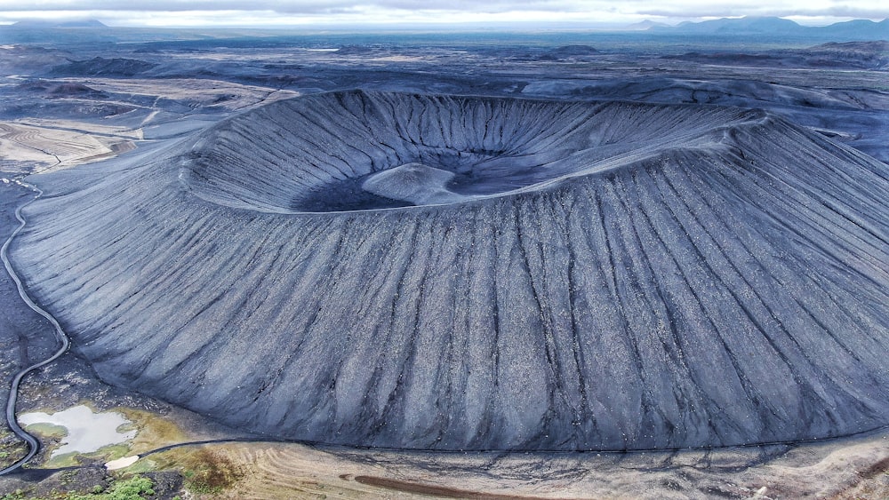 an aerial view of a large crater in the desert