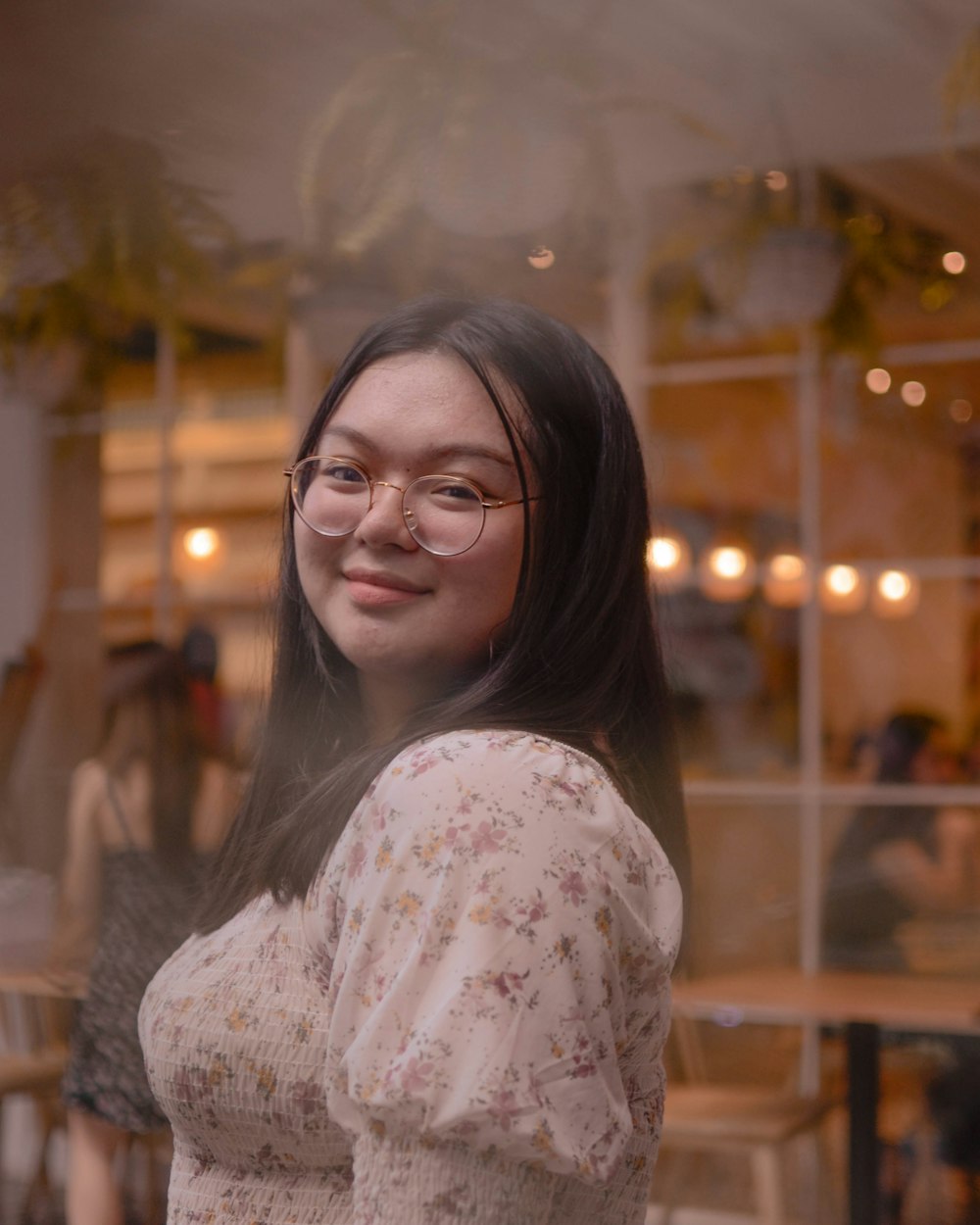 woman wearing white and pink floral dress wearing eyeglasses