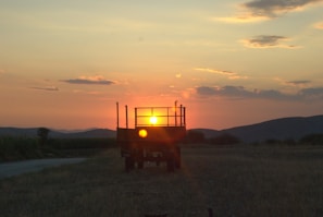 A warm sunset view with the coffee trailer in silhouette.