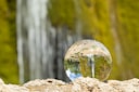 clear glass ball on brown rock