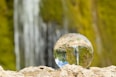 clear glass ball on brown rock