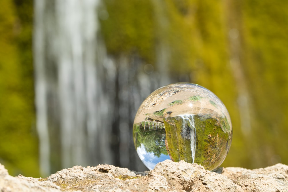 clear glass ball on brown rock