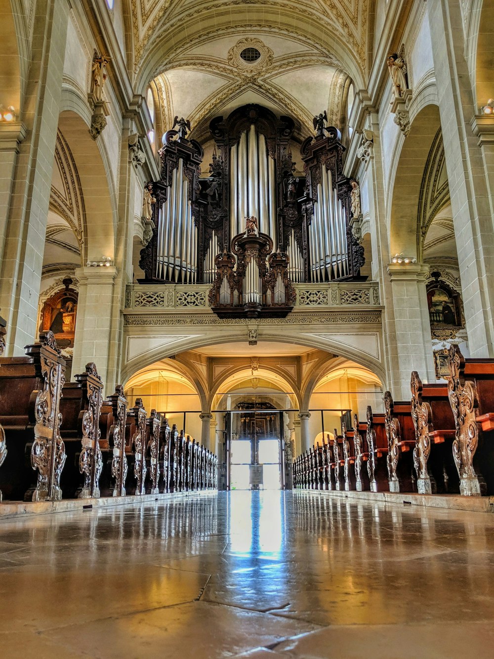 pile of brown benches inside cathedral