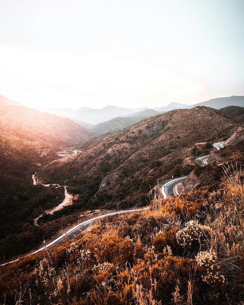 road beside mountain during daytime