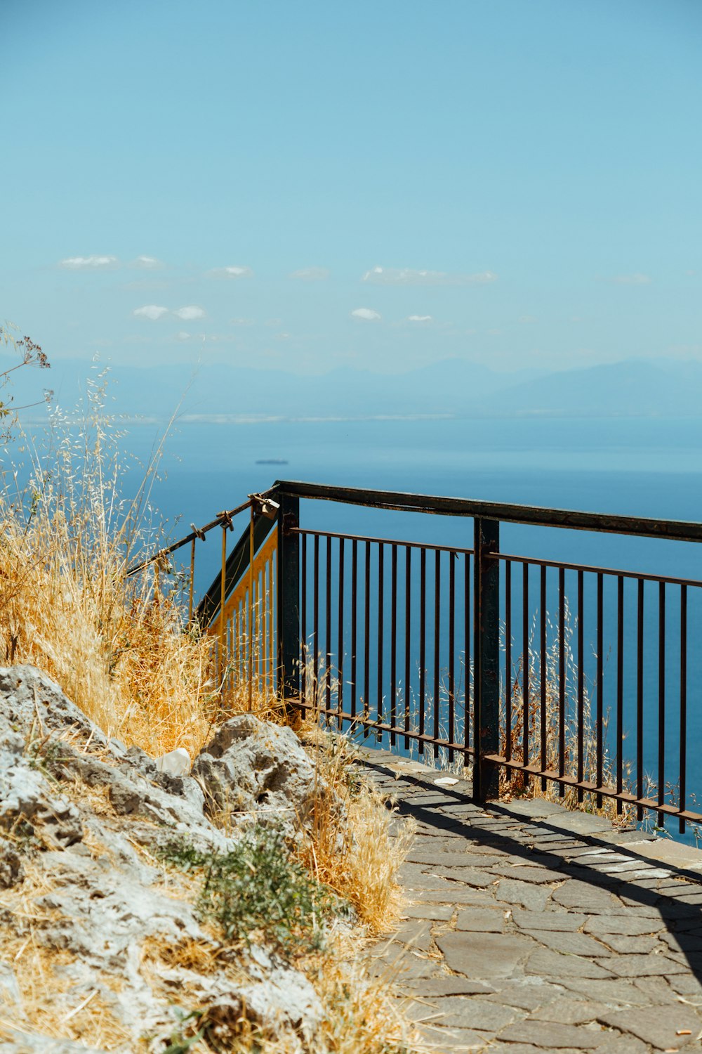 steel fence near water during daytime