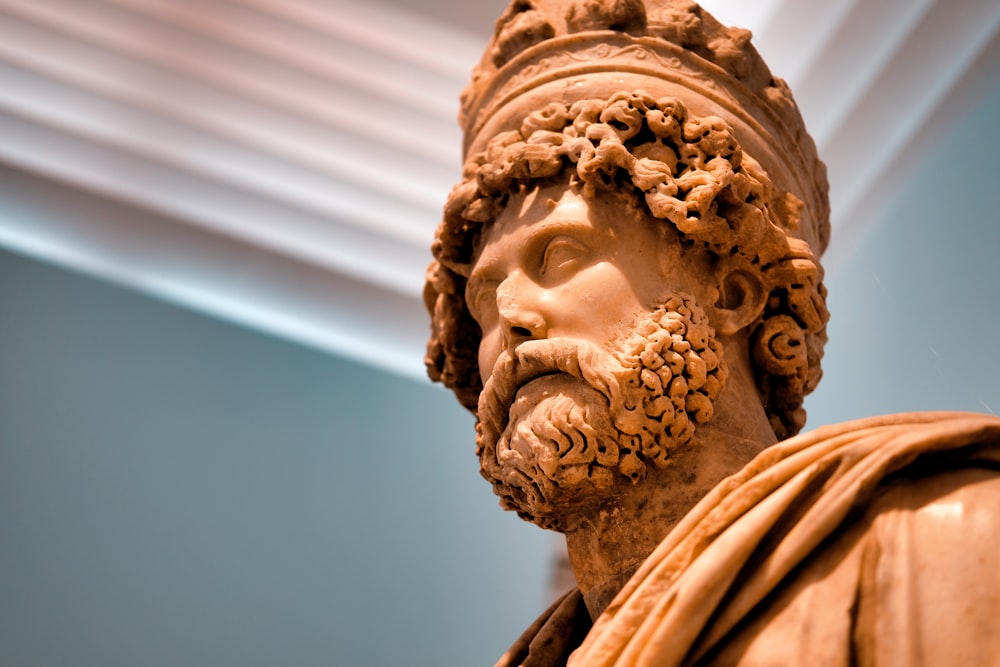 brown statue of man wearing crown