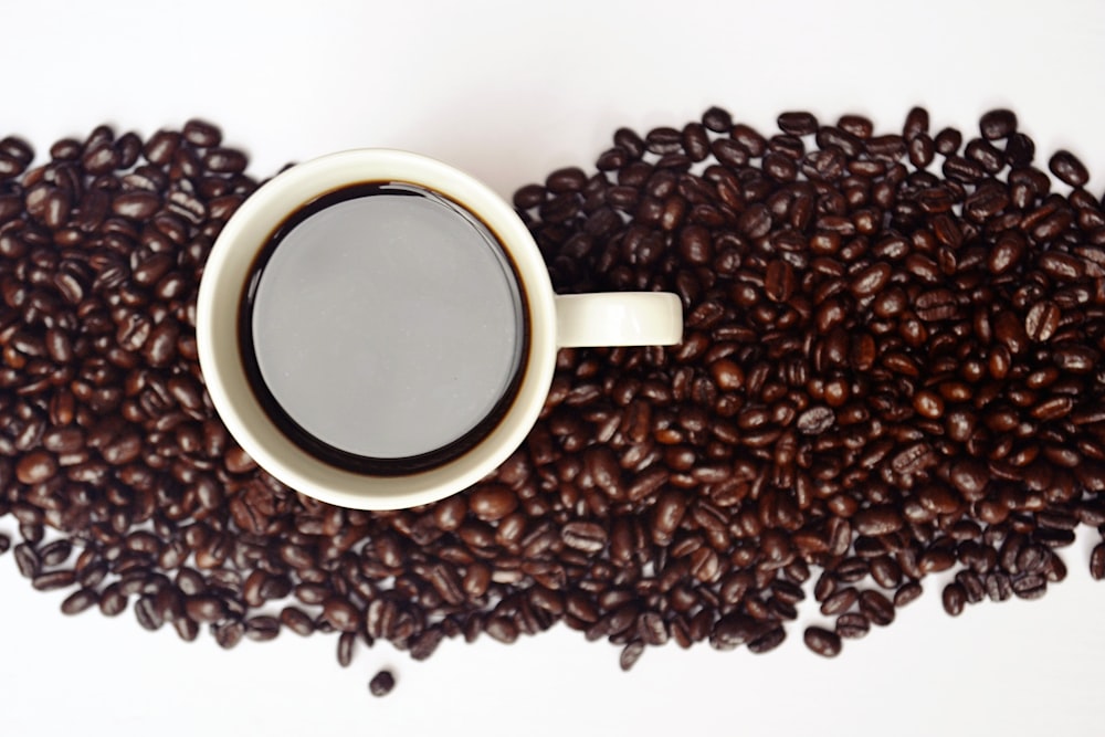 coffee in mug on coffee beans