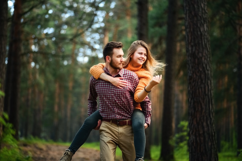 man carrying woman on back