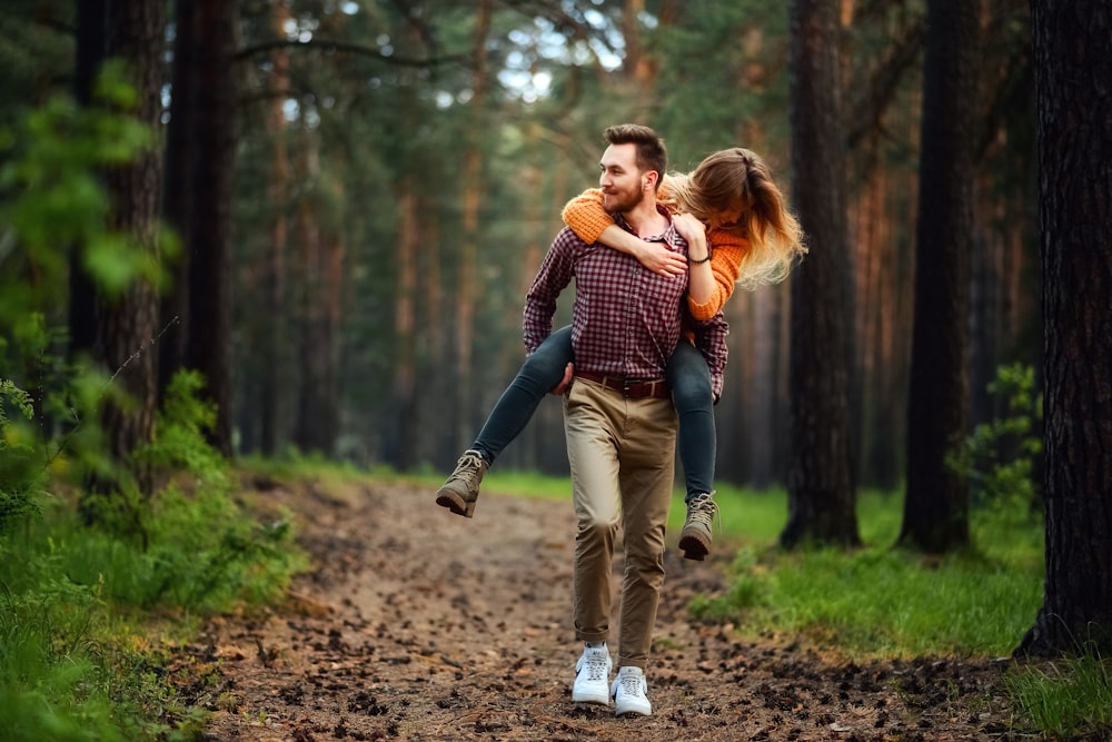 man carrying woman