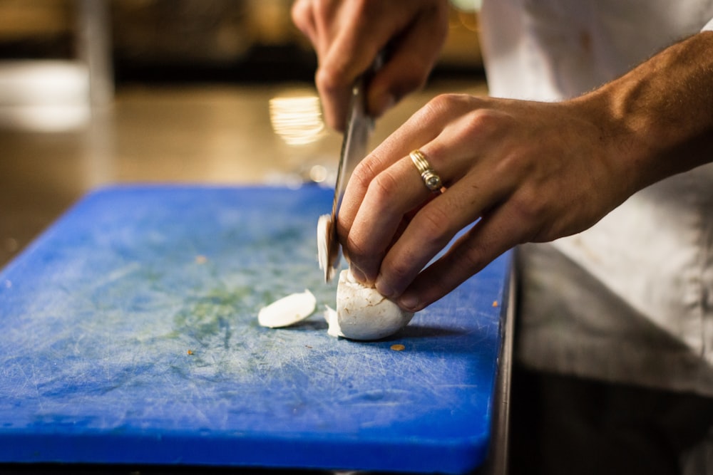 man slicing onion