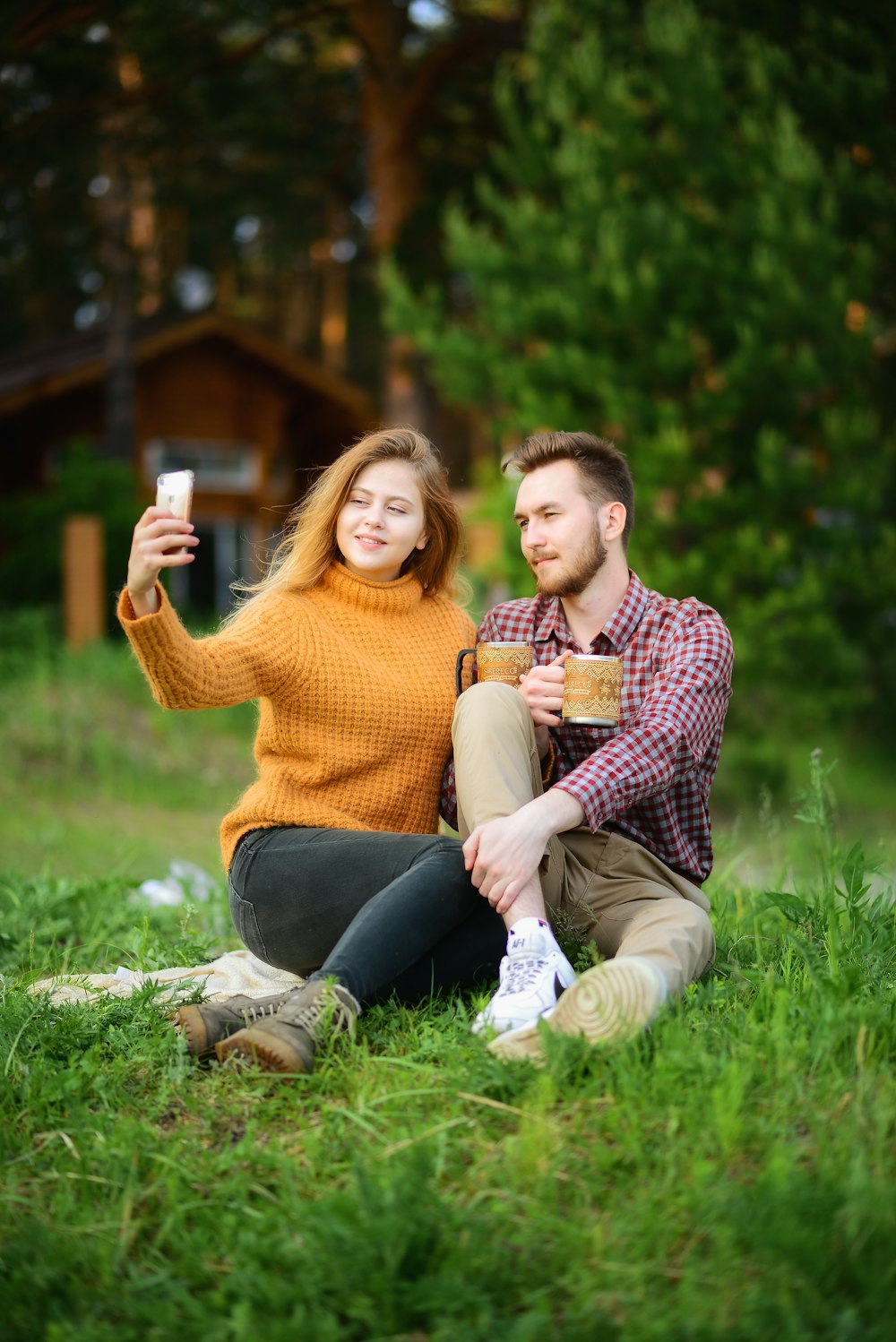 woman taking photo of man and woman