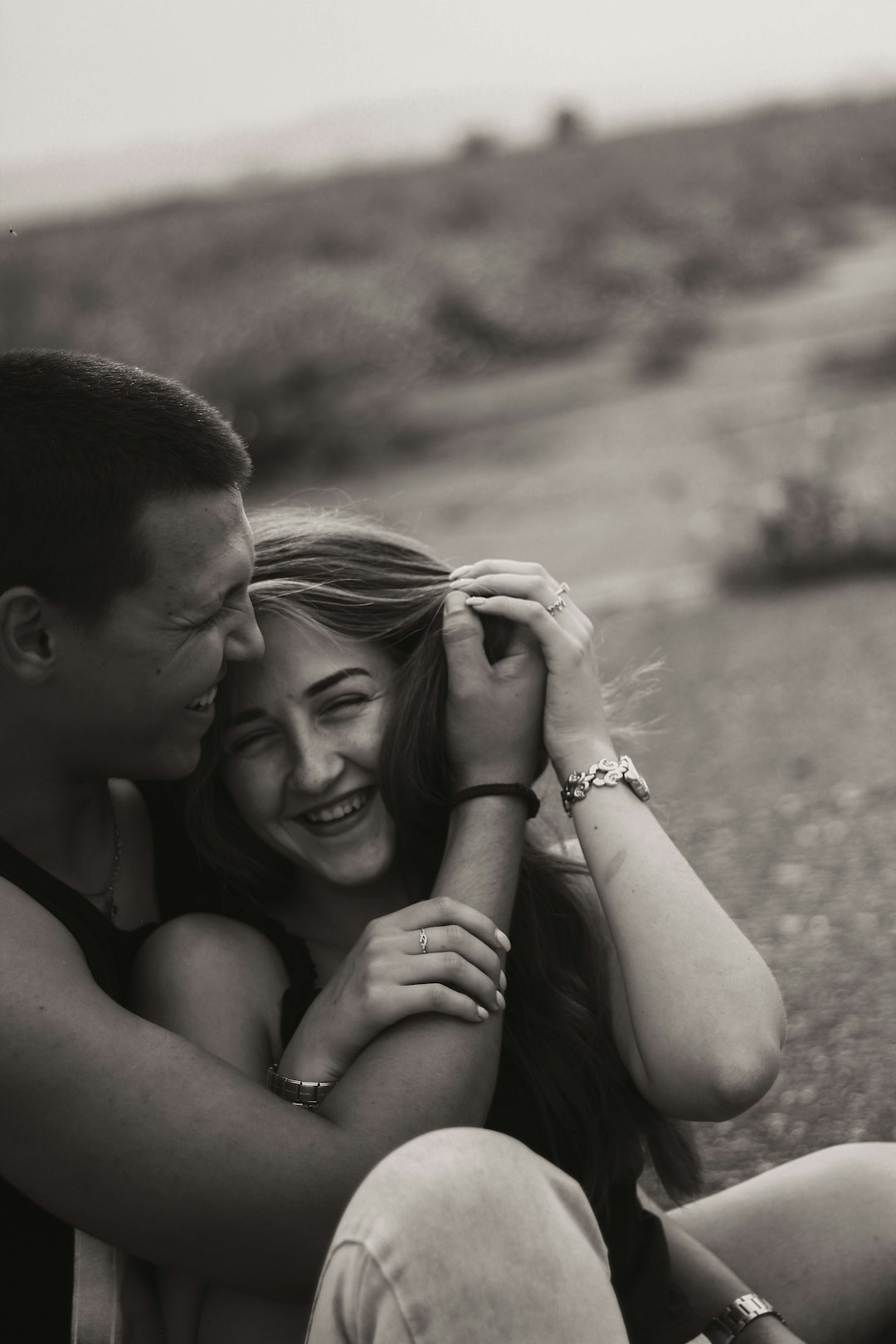 grayscale photo of man and woman smiling