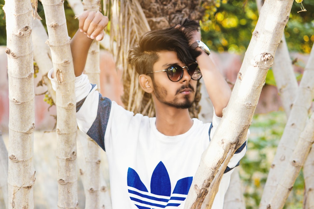 man standing near trees