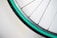 A close-up of a bicycle wheel with shiny spokes and a vibrant tire.