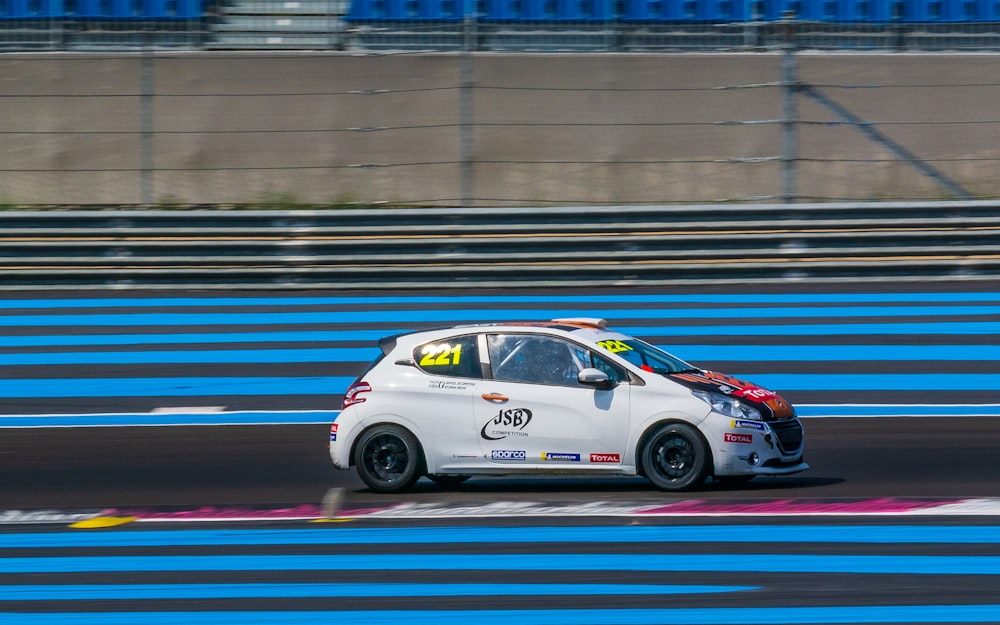 white vehicle on race track during daytime