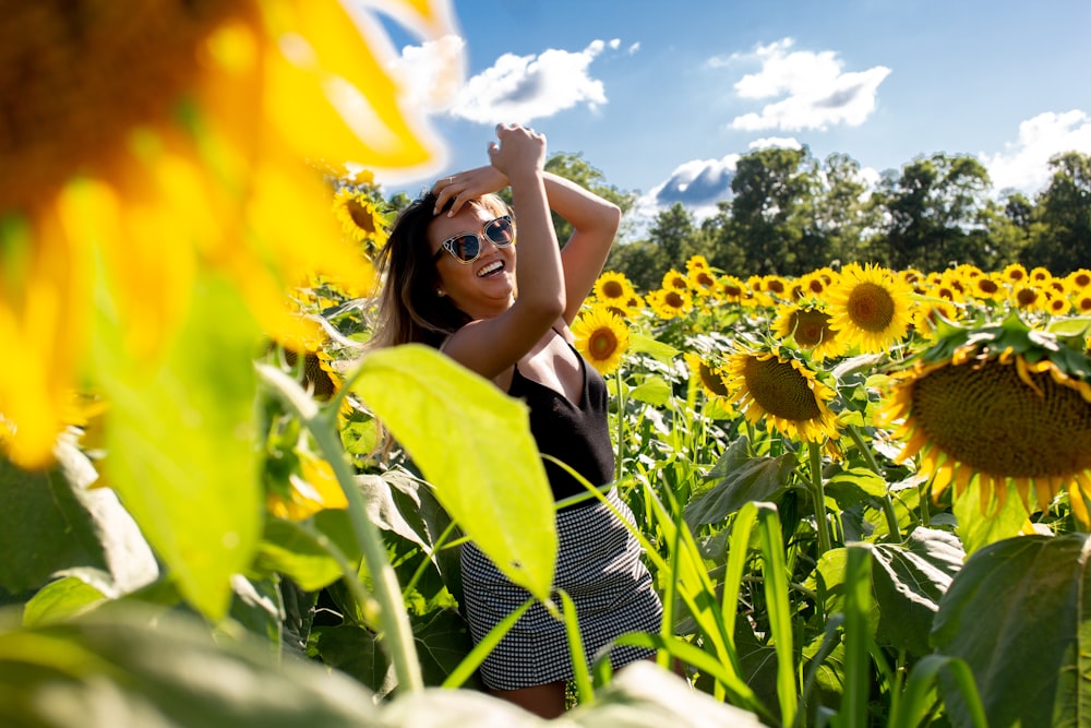 unknown person standing on yellow sunflower field