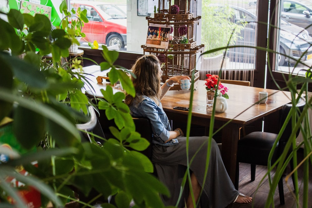 woman sitting near wooden table