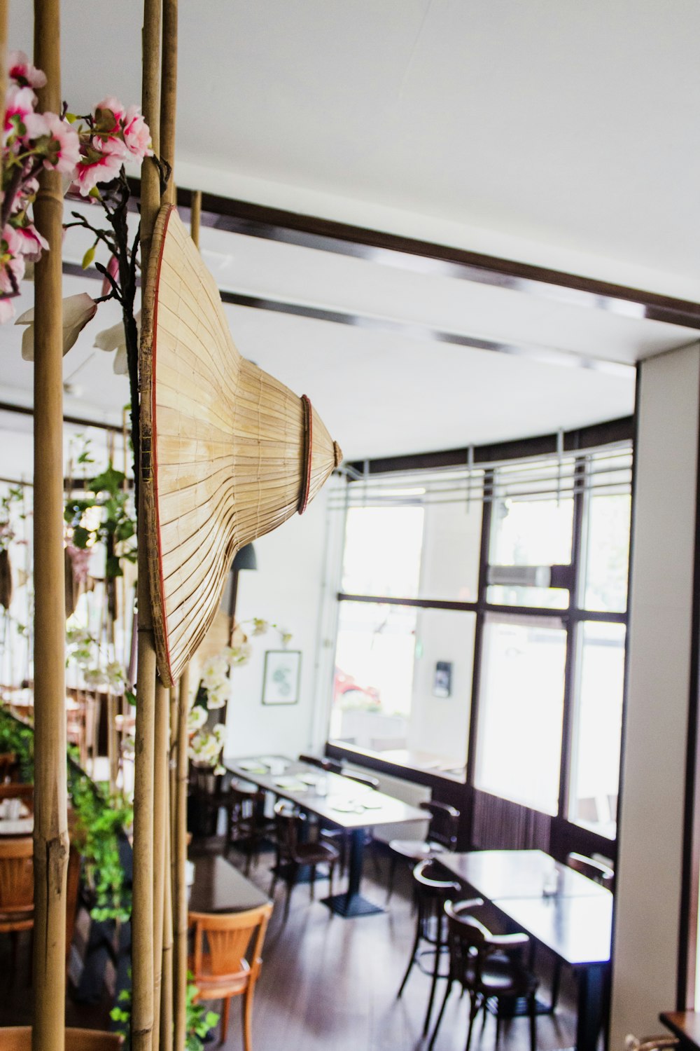 a room with tables, chairs, and umbrellas