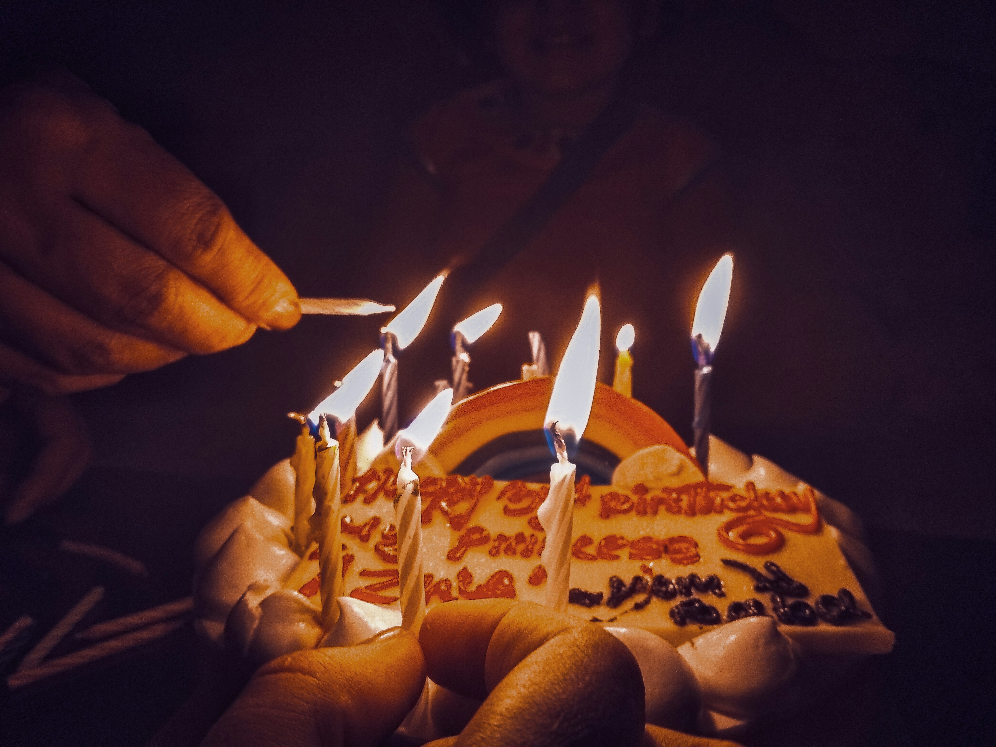 white icing-covered cake with lit candles