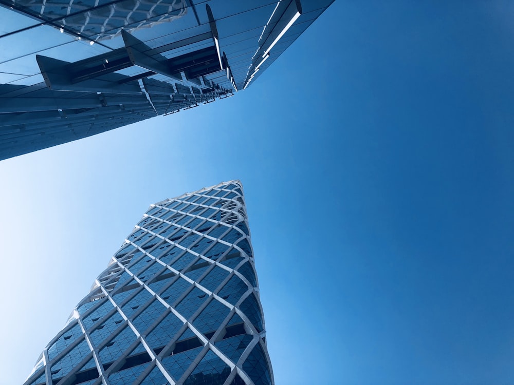 worm's eye view of two white and gray buildings