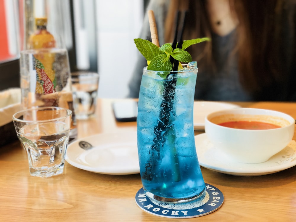blue cocktail drink with mint on table