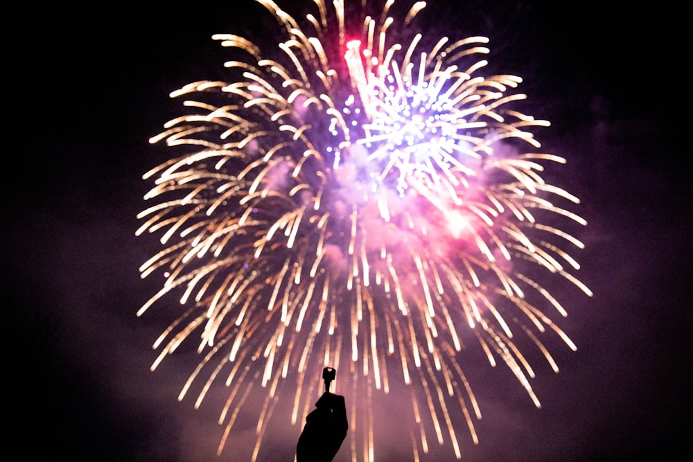 person holding key during firework display during nighttime