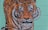 A detailed mural of a tiger's face with an orange and black striped pattern, set against a teal background.