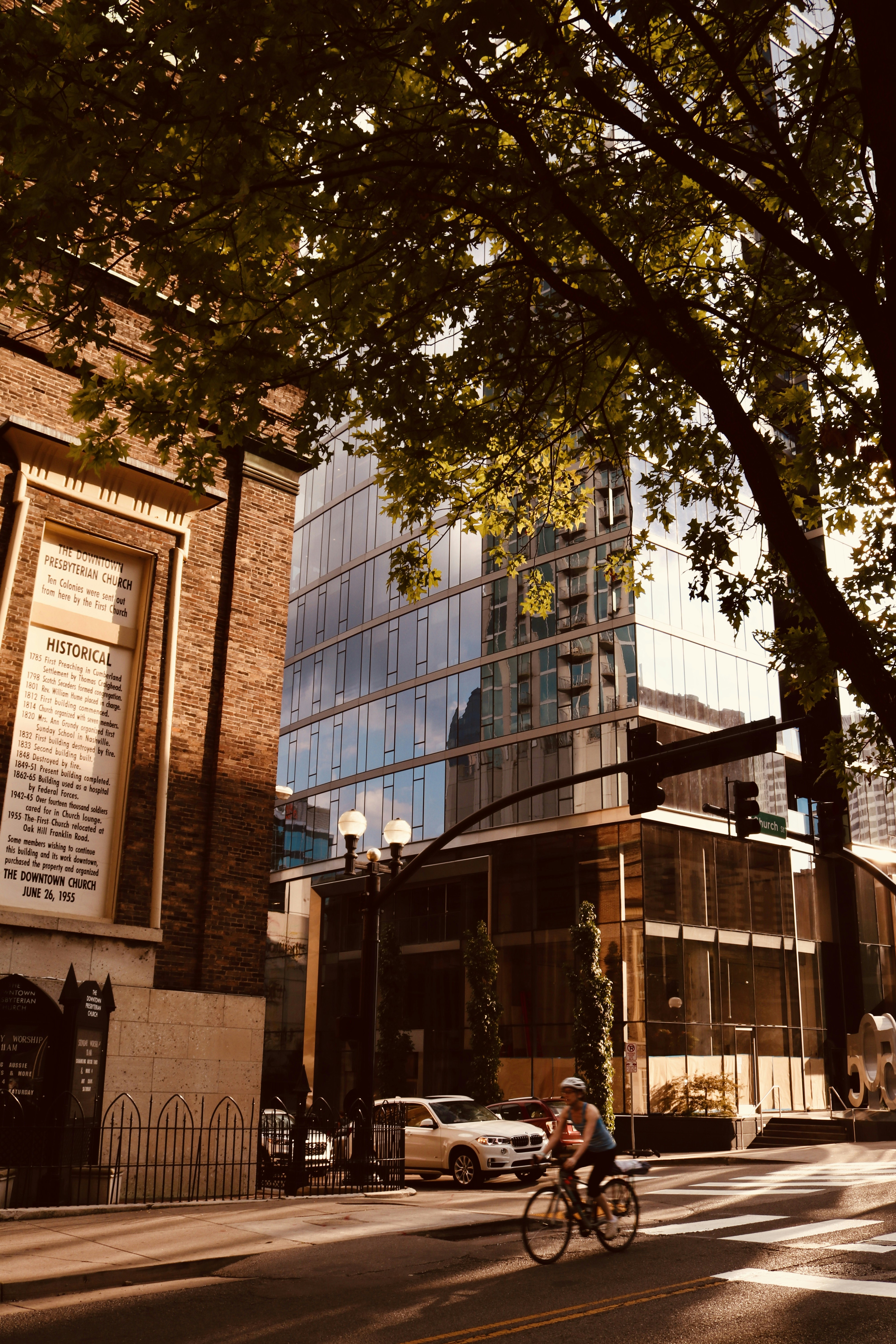 person riding on bicycle beside concrete building
