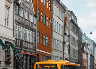 yellow and black bus on road at daytime