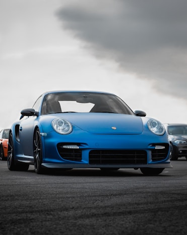 blue luxury porshe on premium tyres sold at the tyrepublic tire shop in lagos