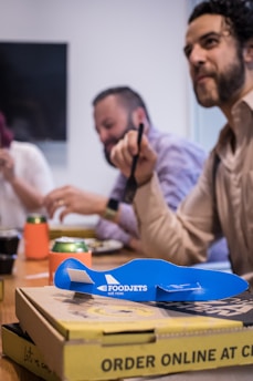 A happy group enjoying a corporate event with bite box platters on the table.