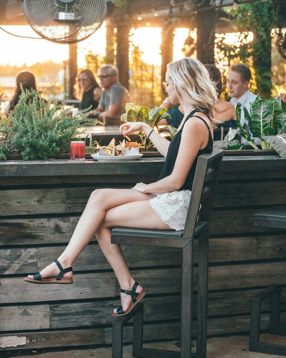 woman about to eat French fries at the bar