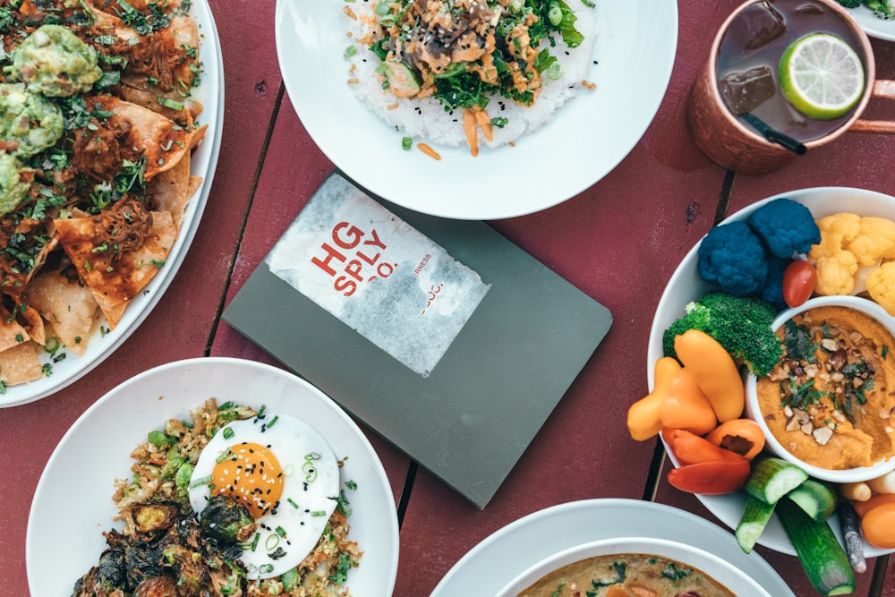 a table topped with plates of food and bowls of soup